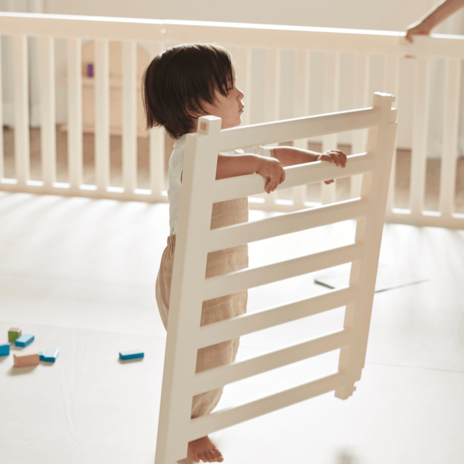Toddler holding a Woodley Babyroom Panel